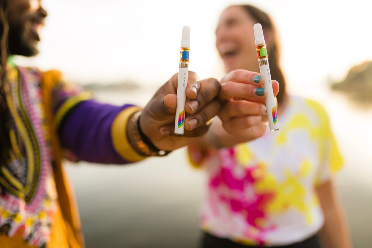 Happy person holding vape pen outdoors